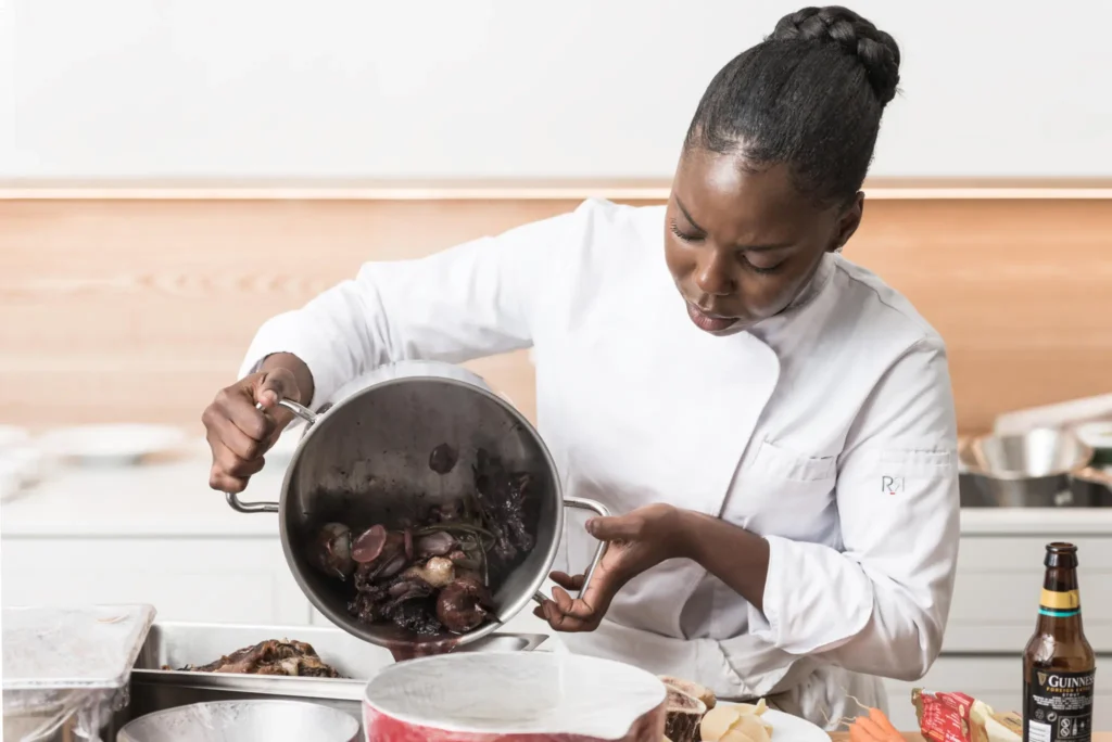 Un chef dresse un plat raffiné illustrant le prix afrocuisine excellence gastronomique
